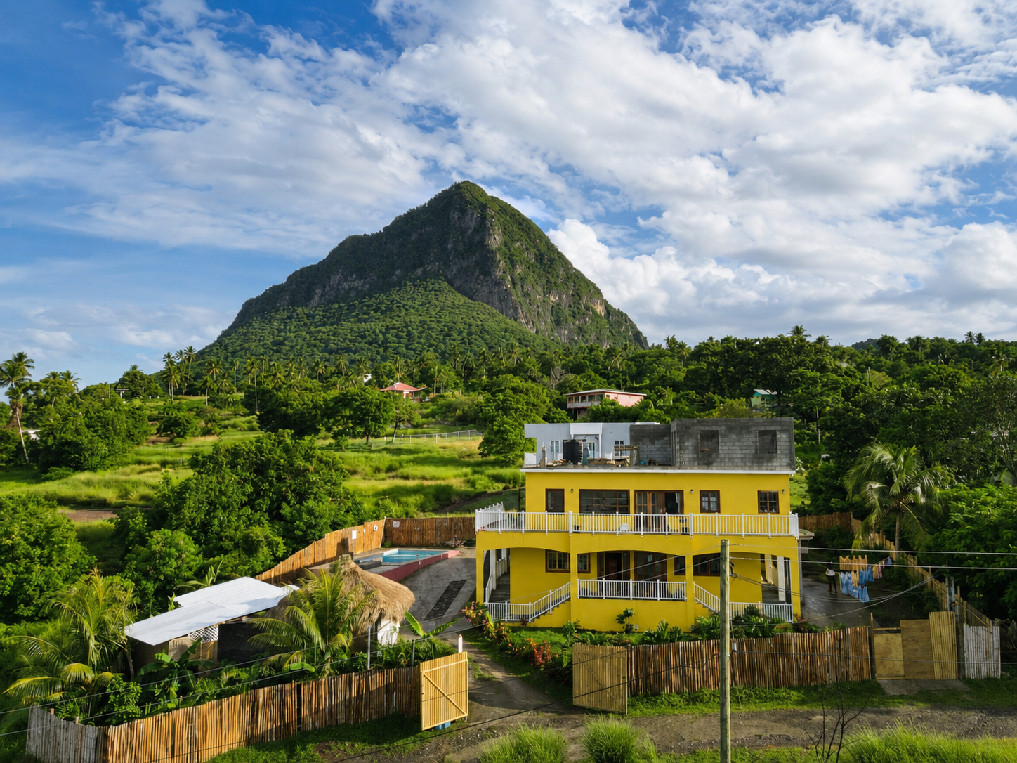 Luxury 5-bedroom villa estate for sale in Choiseul, Saint Lucia, featuring three villas, a pool, outdoor bar and stunning Caribbean Sea and Piton views.